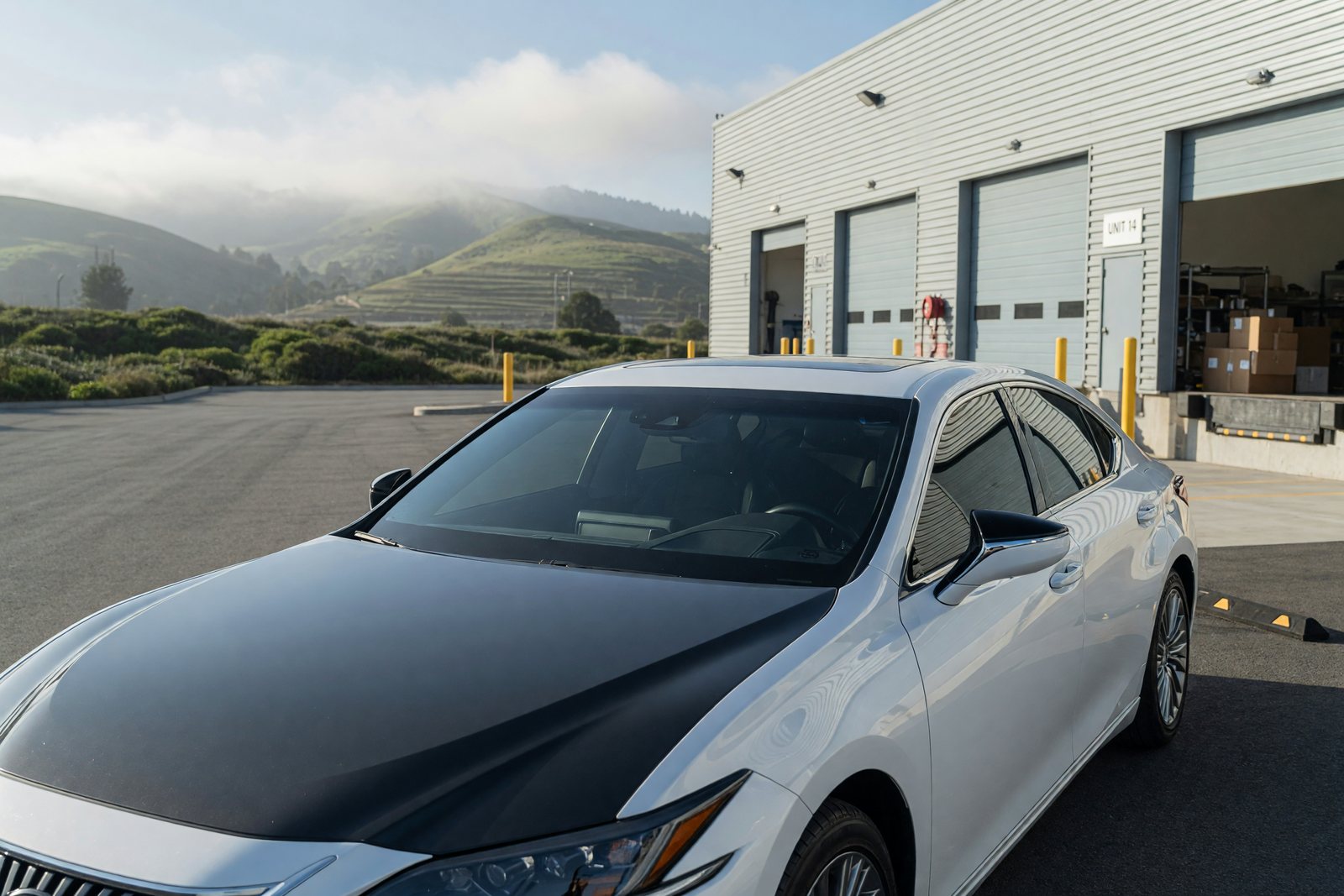Illustration of a white Lexus ES 350 with charcoal color change PPF on the hood and front fenders in morning sunlight