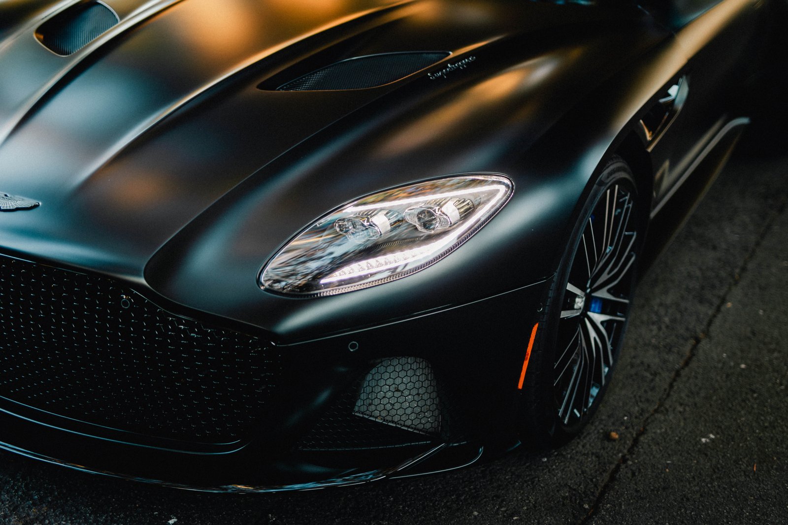 Close-up of a matte black hood and headlight after professional paint protection film
