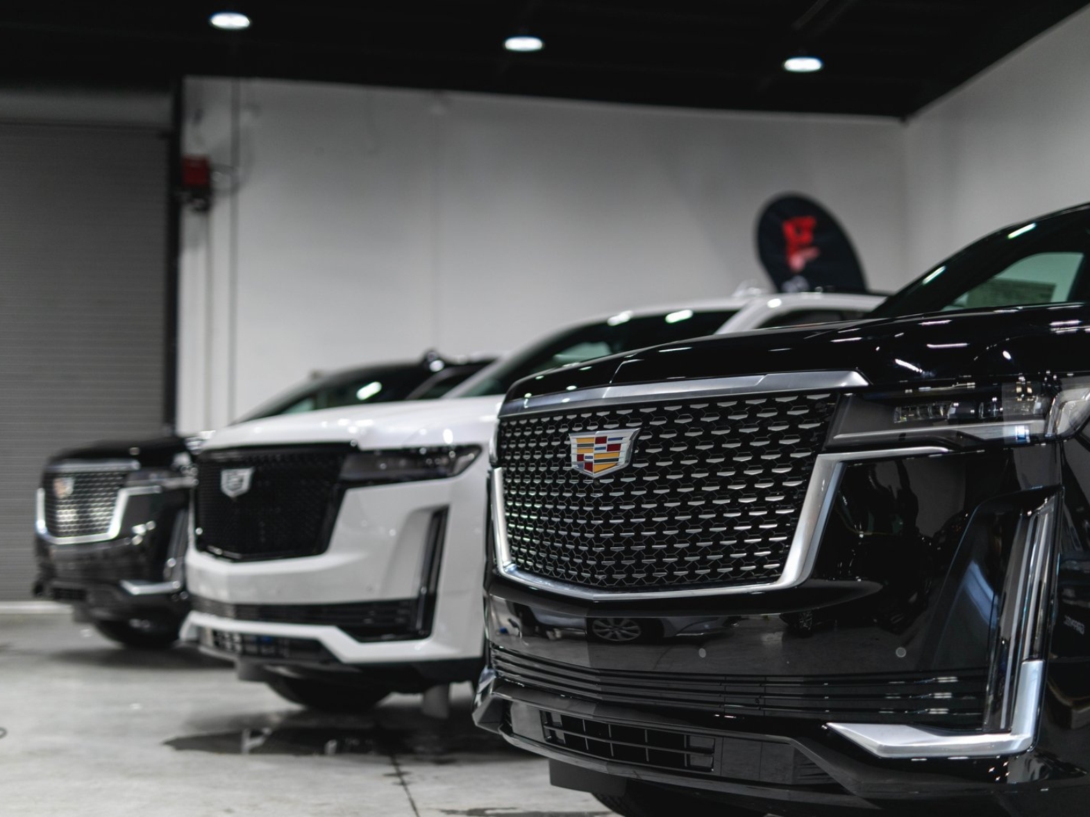 Cadillac SUVs with glossy paint protection in the Graphix Lab South San Francisco shop