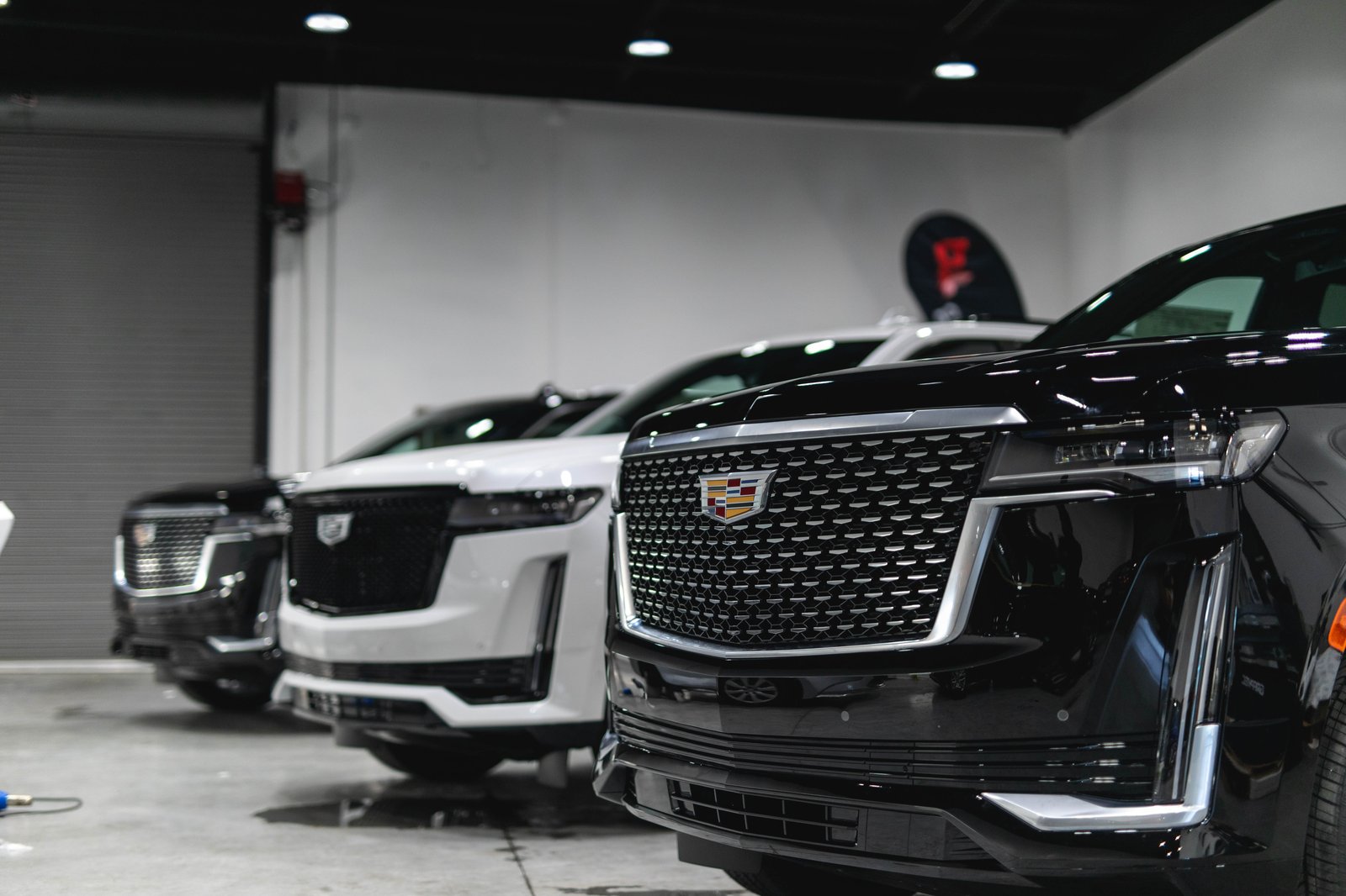 Cadillac SUVs with glossy paint protection in the Graphix Lab South San Francisco shop